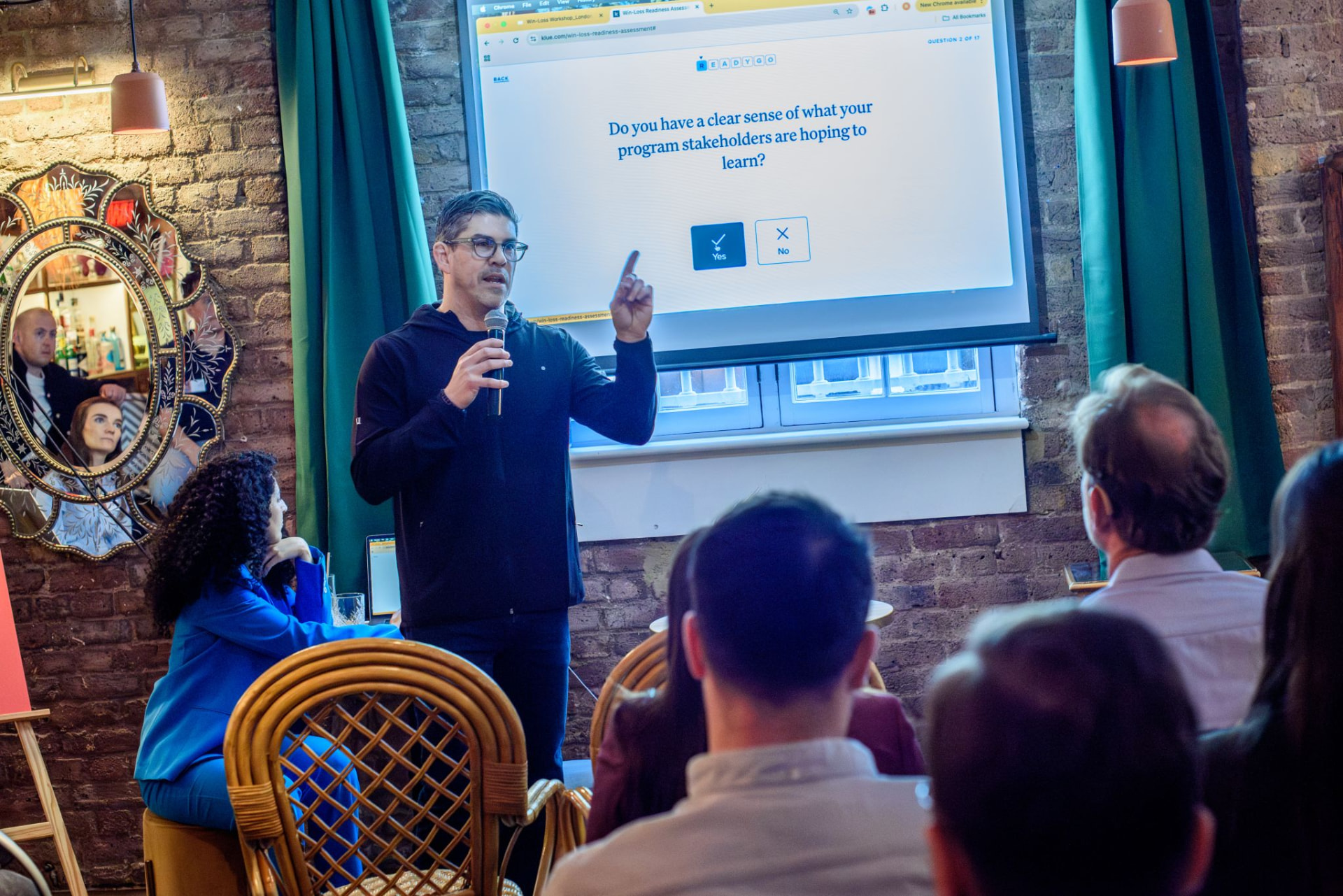Ryan Sorley leading a live cohort video session with product marketers holding the Blindspots book